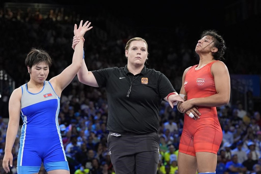India's Nisha Nisha, right, reacts after the women's freestyle 68kg wrestling quarterfinal match against North Korea's Sol Gum Pak, left, at Champ-de-Mars Arena, during the 2024 Summer Olympics, Monday, Aug. 5, 2024, in Paris, France. (AP Photo/Eugene Hoshiko)