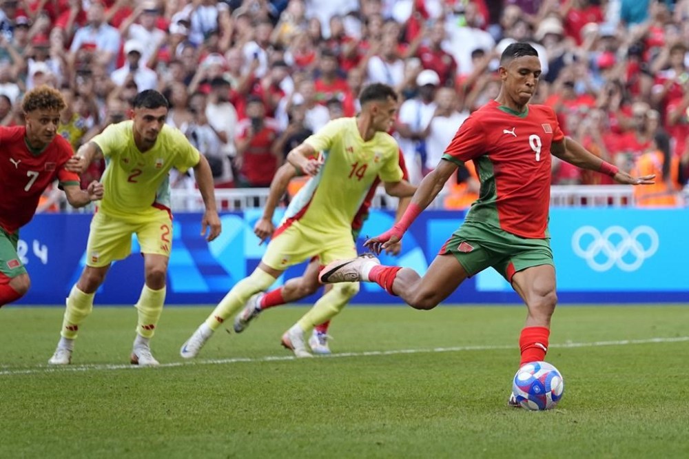 Morocco's Soufiane Rahimi scores a penalty goal during a men's semifinal soccer match between Morocco and Spain at the 2024 Summer Olympics, Monday, Aug. 5, 2024, at Marseille Stadium in Marseille, France. (AP Photo/Julio Cortez)
