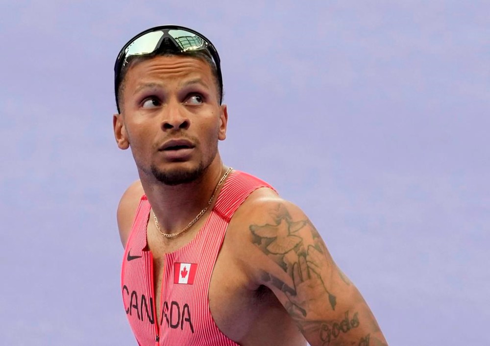 Andre De Grasse, of Canada, looks up at the clock after competing in the men's 100m semi-finals at the 2024 Paris Summer Olympics, Sunday Aug. 4, 2024, in Saint-Denis, France. De Grasse has advanced into the Olympic men's 200-metre semifinals.THE CANADIAN PRESS/Adrian Wyld