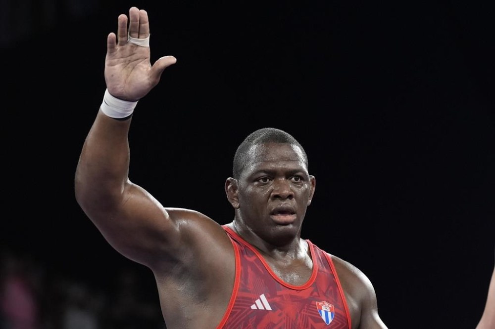 Cuba's Mijain Lopez celebrates after defeating Azerbaijan's Sabah Shariati during their men's Greco-Roman 130kg wrestling semifinal match, at Champ-de-Mars Arena, during the 2024 Summer Olympics, Monday, Aug. 5, 2024, in Paris, France. (AP Photo/Eugene Hoshiko)
