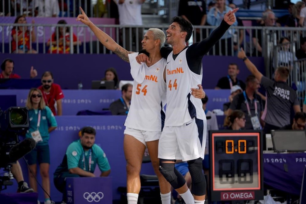 Netherlands' Worthy de Jong (54) and Arvin Slagter celebrate the team's 20-9 win against Lithuania after a men's 3x3 basketball semifinal game during the 2024 Summer Olympics, Monday, Aug. 5, 2024, in Paris, France. (AP Photo/Frank Franklin II)