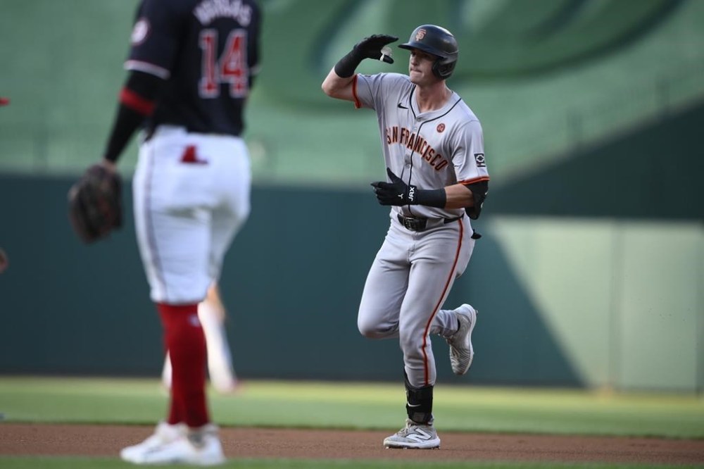 San Francisco Giants' Tyler Fitzgerald, right, celebrates after his home run as he rounds the bases during the first inning of a baseball game against the Washington Nationals, Monday, Aug. 5, 2024, in Washington. (AP Photo/Nick Wass)