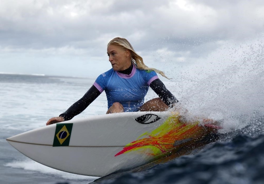 Tatiana Weston-Webb, of Brazil, carves off a wave in the women's gold medal final in the surfing competition during the Paris 2024 Olympic Games in Teahupo'o, Tahiti, Monday, Aug. 5, 2024. (Ben Thouard/Pool Photo via AP)