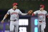 Cincinnati Reds third baseman Noelvi Marte (16) is congratulated by center fielder TJ Friedl (29) after Marte fielded a ground ball hit by Miami Marlins' Emmanuel Rivera and threw him out at first base during the fourth inning of a baseball game, Monday, Aug. 5, 2024, in Miami. (AP Photo/Wilfredo Lee)