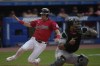 Cleveland Guardians' Lane Thomas slides safely behind Arizona Diamondbacks Gabriel Moreno to score in the first inning of a baseball game in Cleveland, Monday, Aug. 5, 2024. (AP Photo/Sue Ogrocki)