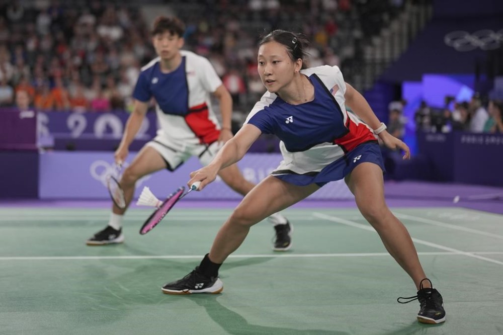 United States' Vinson Chiu and Jennie Gai, right, play against China's Feng Yan Zhe and Huang Dong Ping during their mixed doubles badminton group stage match at Porte de la Chapelle Arena during the 2024 Summer Olympics, Saturday, July 27, 2024, in Paris, France. (AP Photo/Dita Alangkara)