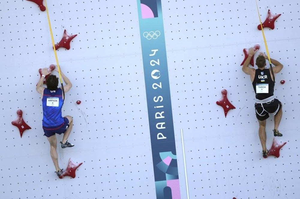 Sam Watson of the United States, left, and Yaroslav Tkach of Ukraine compete in the men's speed, qualification seeding, during the sport climbing competition at the 2024 Summer Olympics, Tuesday, Aug. 6, 2024, in Le Bourget, France. (AP Photo/Tsvangirayi Mukwazhi)