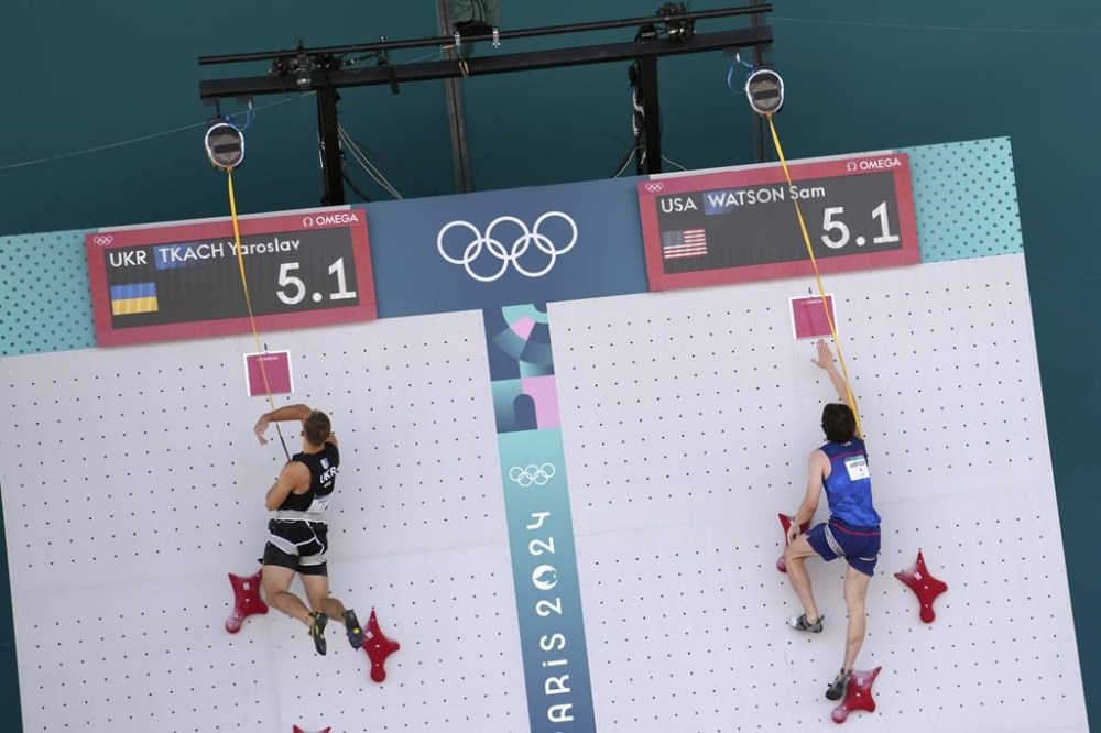 Yaroslav Tkach of Ukraine, left, and Sam Watson of the United States compete in the men's speed, qualification seeding, during the sport climbing competition at the 2024 Summer Olympics, Tuesday, Aug. 6, 2024, in Le Bourget, France. (AP Photo/Tsvangirayi Mukwazhi)