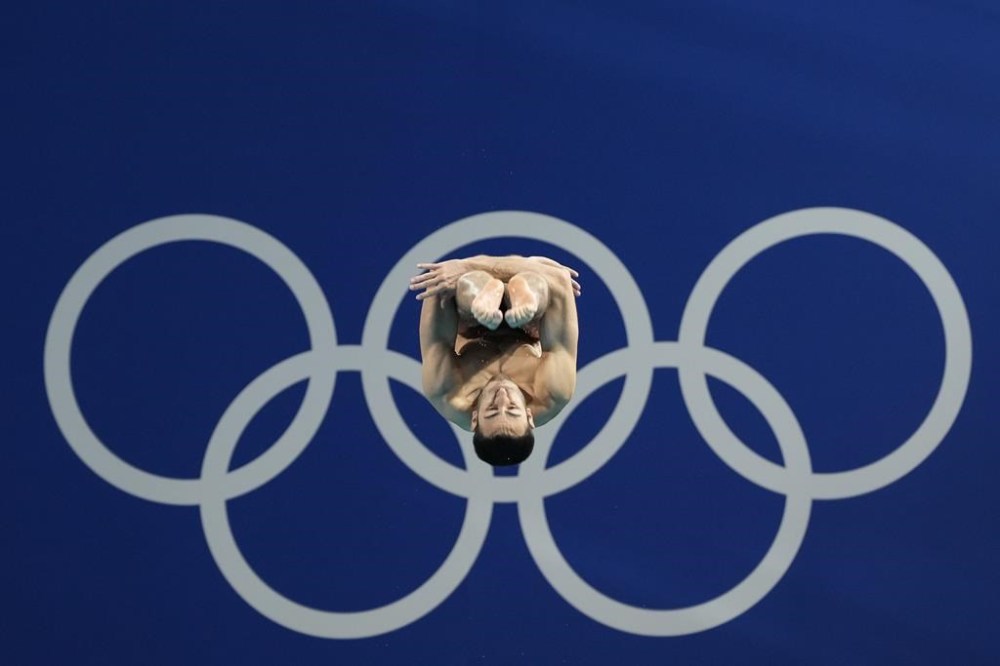 Italy's Giovanni Tocci competes in the men's 3m springboard diving preliminary at the 2024 Summer Olympics, Tuesday, Aug. 6, 2024, in Saint-Denis, France. (AP Photo/Lee Jin-man)