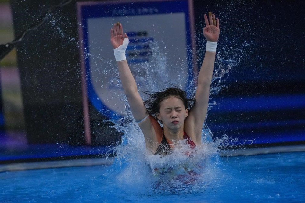 China's Quan Hongchan practices before competing in the men's 3m springboard diving preliminary at the 2024 Summer Olympics, Tuesday, Aug. 6, 2024, in Saint-Denis, France. (AP Photo/Dar Yasin)
