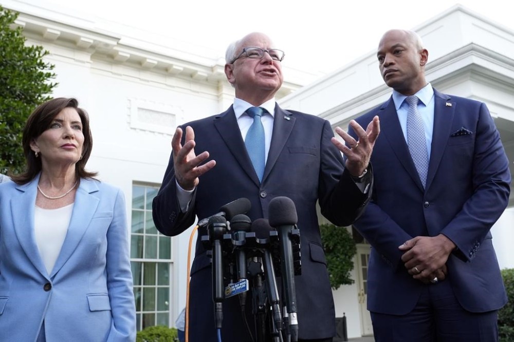 FILE - Minnesota Gov. Tim Walz, center, standing with New York Gov. Kathy Hochul, left, and Maryland Gov. Wes Moore, right, talks with reporters following their meeting with President Joe Biden at the White House in Washington, July 3, 2024. (AP Photo/Susan Walsh, File)