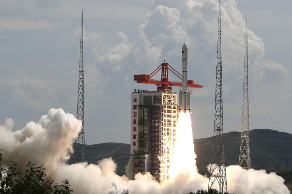 In this photo released by Xinhua News Agency, a modified Long March-6 carrier rocket carrying a new satellite group blasts off from the Taiyuan Satellite Launch Center in north China's Shanxi Province on Tuesday, Aug. 6, 2024. China says it launched the rocket Tuesday carrying a constellation of a reported 18 satellites as part of efforts to assert its presence in space. (Zheng Bin/Xinhua via AP)