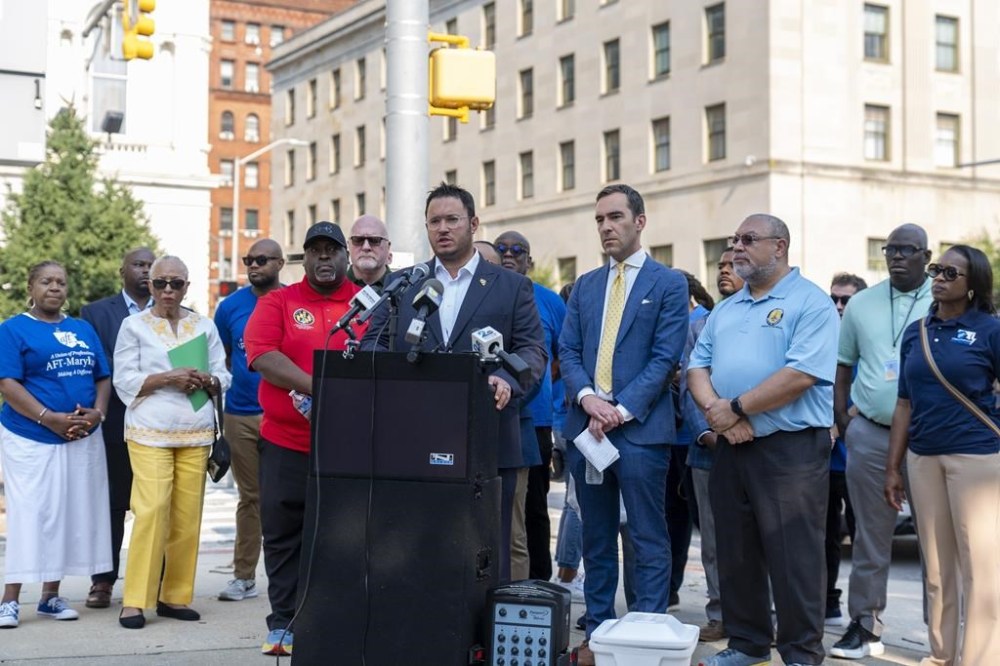 Baltimore City Councilmember Isaac Schleifer, center, speaks at a news conference demanding safe working conditions for Baltimore City Department of Public Works employees, Tuesday, Aug. 6, 2024, in Baltimore. (AP Photo/Stephanie Scarbrough)