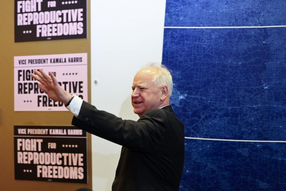 FILE - Minnesota Governor Tim Walz greets reporters before Vice President Kamala Harris speaks at Planned Parenthood, March 14, 2024, in St. Paul, Minn. (AP Photo/Adam Bettcher, File)