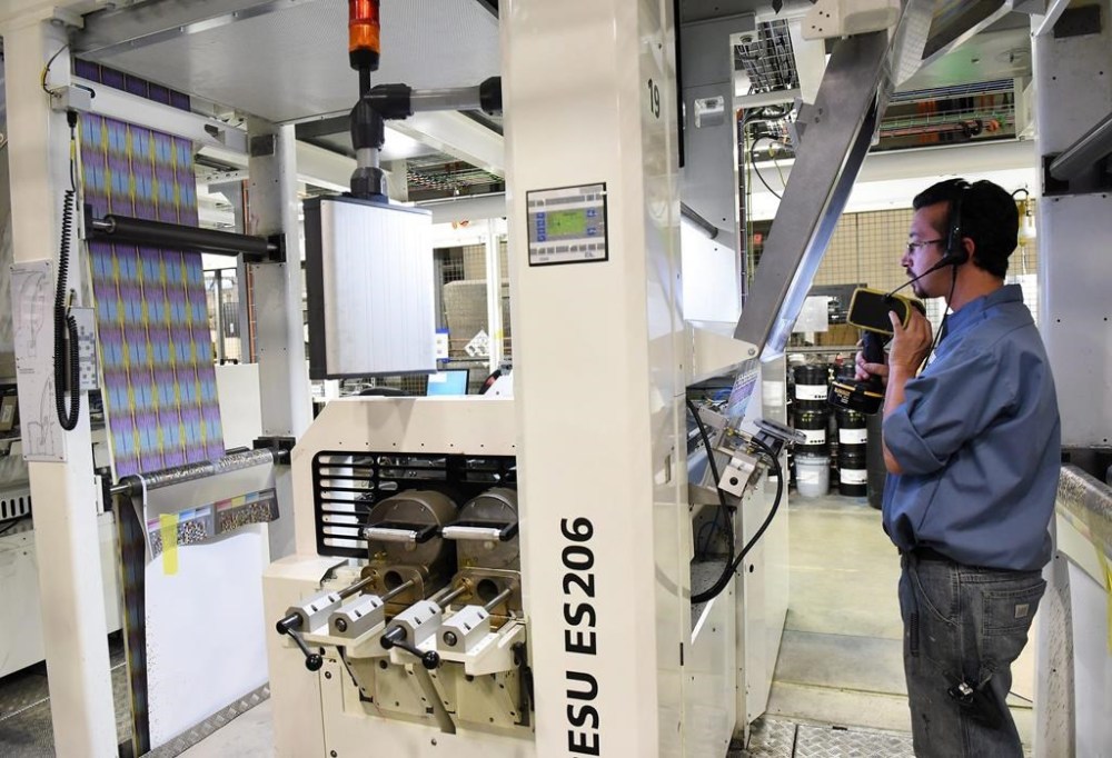 Shares of Pollard Banknote Ltd. fell more than 30 per cent after the company said the Michigan Lottery plans to go with another supplier for its iLottery and related services when its contract expires. Mark Mull, right, checks to make sure the printer is in register while it is in operation at Pollard Banknote Limited in Ypsilanti, Mich. THE CANADIAN PRESS/AP-The Detroit News, Robin Buckson