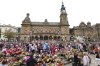 Members of the public form bubbles outside the Town Hall during a vigil to remember the victims of the stabbing attack last Monday in Southport, England, Monday, Aug. 5, 2024. Violence and unrest erupted in cities and towns across Britain, ostensibly in protest of last week's stabbing. (AP Photo/Darren Staples)