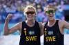 Sweden's David Ahmad, left, and Jonatan Hellvig strike a celebratory pose after defeating Brazil in a quarterfinal beach volleyball match at the 2024 Summer Olympics, Tuesday, Aug. 6, 2024, in Paris, France. (AP Photo/Robert F. Bukaty)