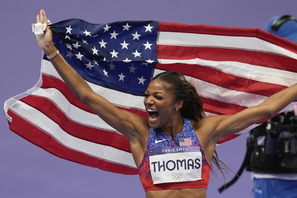 Gabrielle Thomas, of the United States, celebrates her win in the women's 200-meter final at the 2024 Summer Olympics, Tuesday, Aug. 6, 2024, in Saint-Denis, France. (AP Photo/Rebecca Blackwell)