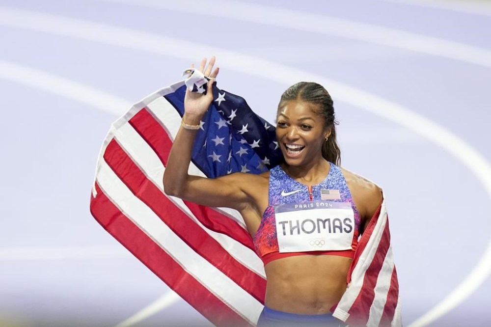 Gabrielle Thomas, of the United States, celebrates after winning the women's 200-meters final at the 2024 Summer Olympics, Tuesday, Aug. 6, 2024, in Saint-Denis, France. (AP Photo/Natacha Pisarenko)