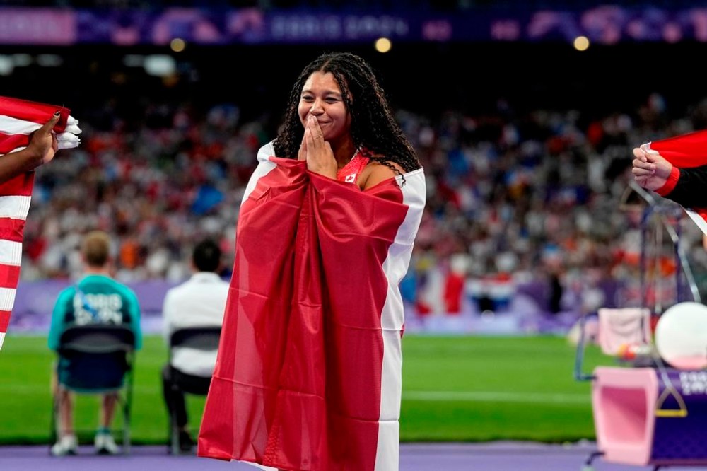 Canada's Camryn Rogers celebrates her gold medal won in the women's hammer throw event at the Summer Olympics in Paris, Tuesday, Aug. 6, 2024. THE CANADIAN PRESS/Adrian Wyld