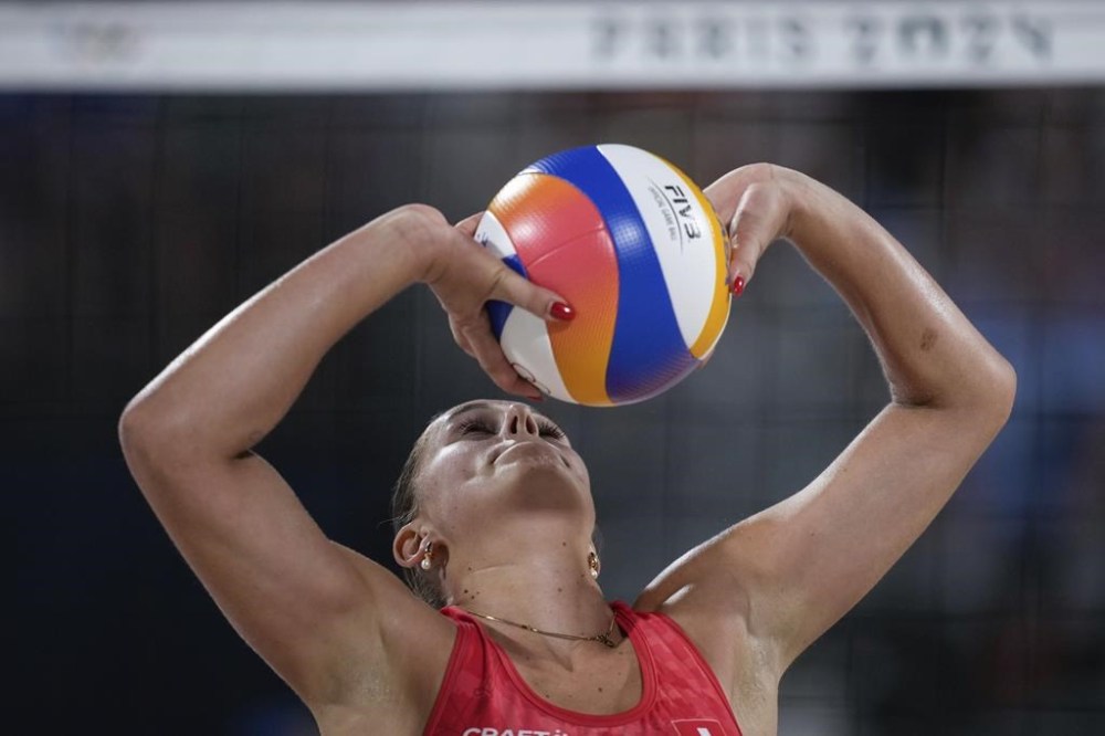Switzerland's Esmee Boebner hits the ball during the women's quaterfinal beach volleyball match between Australia and Switzerland at Eiffel Tower Stadium at the 2024 Summer Olympics, Tuesday, Aug. 6, 2024, in Paris, France. (AP Photo/Louise Delmotte)