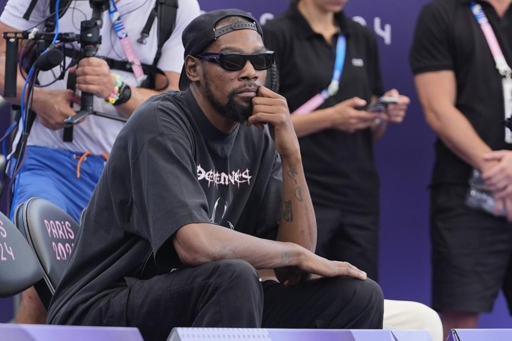 Kevin Durant watches the women's 3x3 basketball pool round match between the United States and Australia during the 2024 Summer Olympics, Thursday, Aug. 1, 2024, in Paris, France. Australia won 17-15. (AP Photo/Frank Franklin II)
