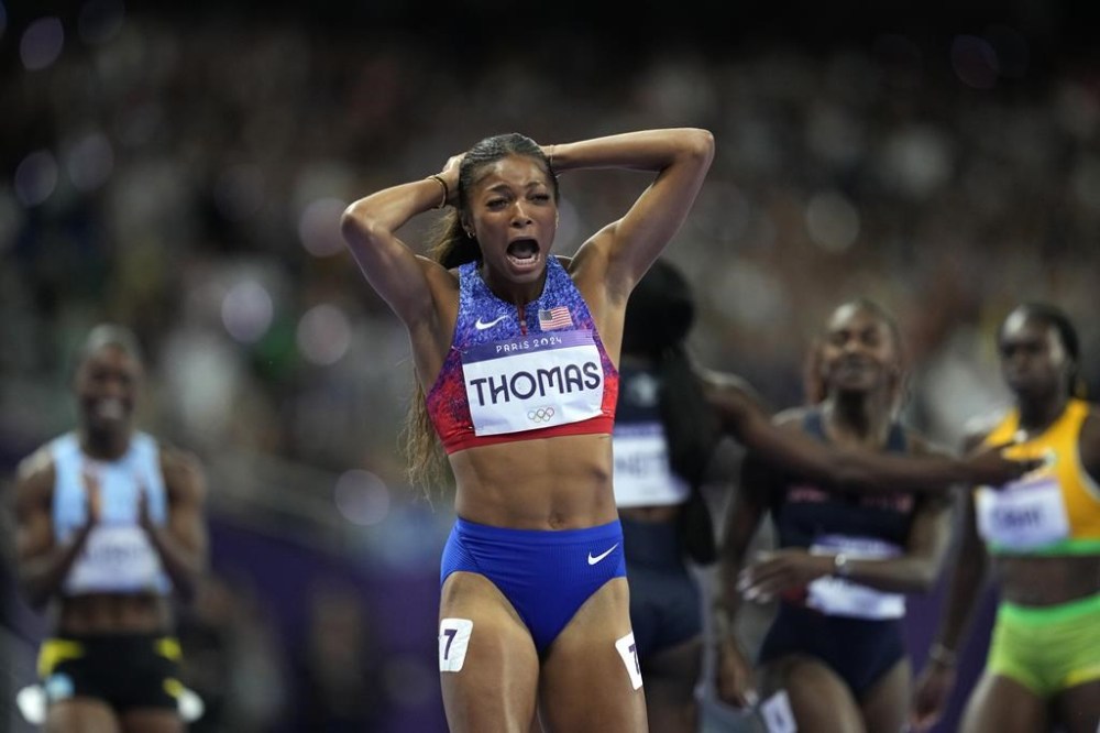 Gabrielle Thomas, of the United States, reacts to winning the gold medal in the women's 200 meters final at the 2024 Summer Olympics, Tuesday, Aug. 6, 2024, in Saint-Denis, France. (AP Photo/Ashley Landis)