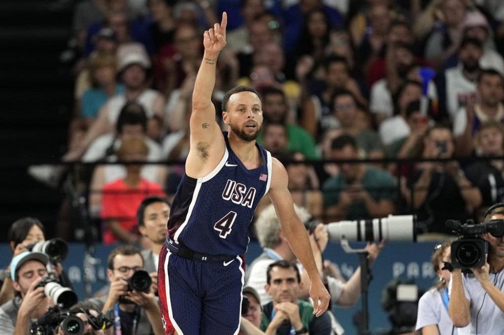 United States' Stephen Curry gestures after scoring during a men's basketball game against Brazil at the 2024 Summer Olympics, Tuesday, Aug. 6, 2024, in Paris, France. (AP Photo/Michael Conroy)
