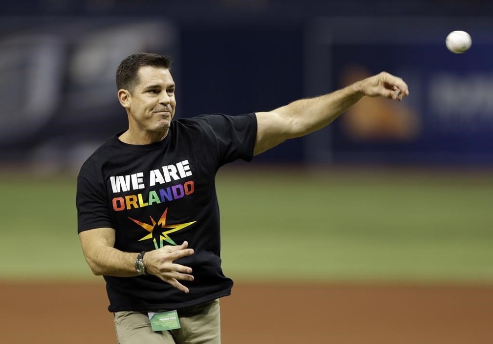 FILE - Bill Bean, MLB's vice president of Social Responsibility and Inclusion, throws out the ceremonial first pitch before a baseball game between the Tampa Bay Rays and the San Francisco Giants, June 17, 2016, in St. Petersburg, Fla. (AP Photo/Chris O'Meara, File)