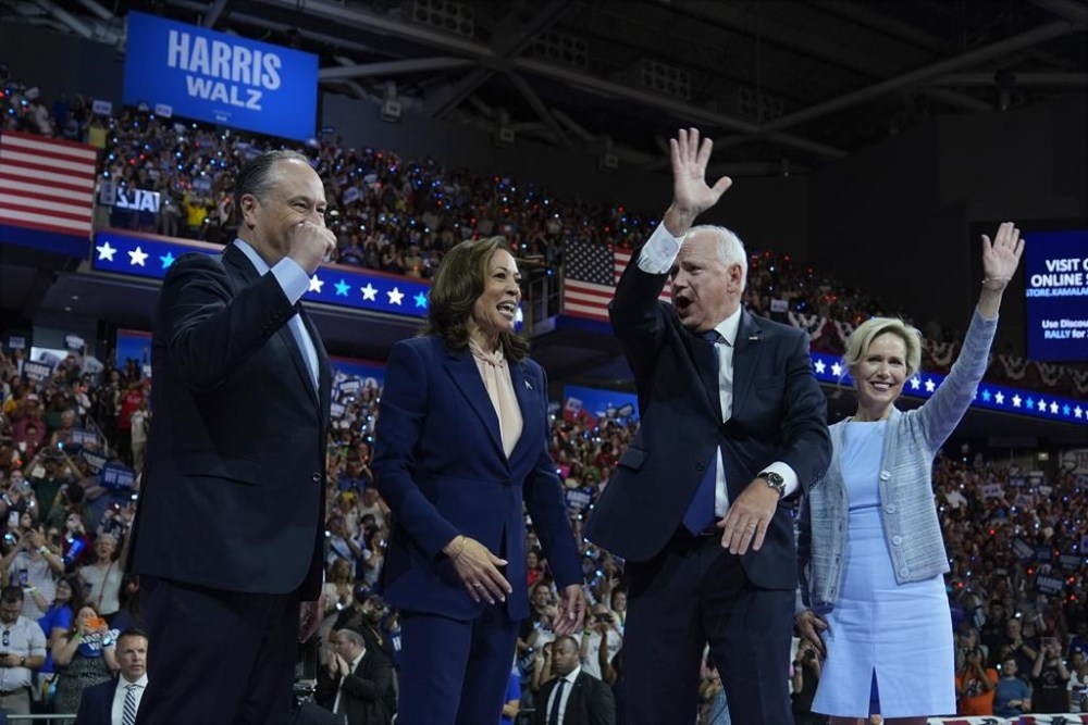Democratic presidential nominee Vice President Kamala Harris and second gentleman Doug Emhoff along with her running mate Minnesota Gov. Tim Walz and his wife Gwen Walz appear at a campaign rally in Philadelphia, Tuesday, Aug. 6, 2024. (AP Photo/Matt Rourke)