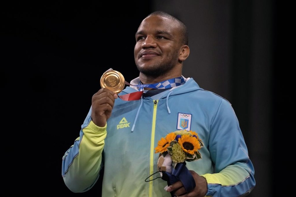 FILE - Gold medalist, Zhan Beleniuk of Ukraine, celebrates on the podium during the medal ceremony for the men's 87kg Greco-Roman wrestling at the 2020 Summer Olympics, Wednesday, Aug. 4, 2021, in Chiba, Japan. (AP Photo/Aaron Favila, File)
