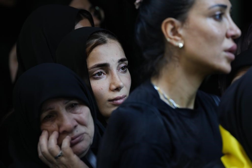 Mourners attend the funeral of Hezbollah commander Ali Jawad who was killed on Monday by an Israeli airstrike, in Beirut, Lebanon, Tuesday, Aug. 6, 2024. Since early October, Hezbollah began attacking Israeli military posts along the border calling it a backup front for their Palestinian allies in the Gaza Strip. (AP Photo/Hussein Malla)