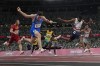 FILE - Filippo Tortu, of Italy, crosses the finish line ahead of Nethaneel Mitchell-Blake, of Britain, to lead his team to a gold medal in the men's 4x100-meter relay at the 2020 Summer Olympics, Aug. 6, 2021, in Tokyo. (AP Photo/David J. Phillip, File)