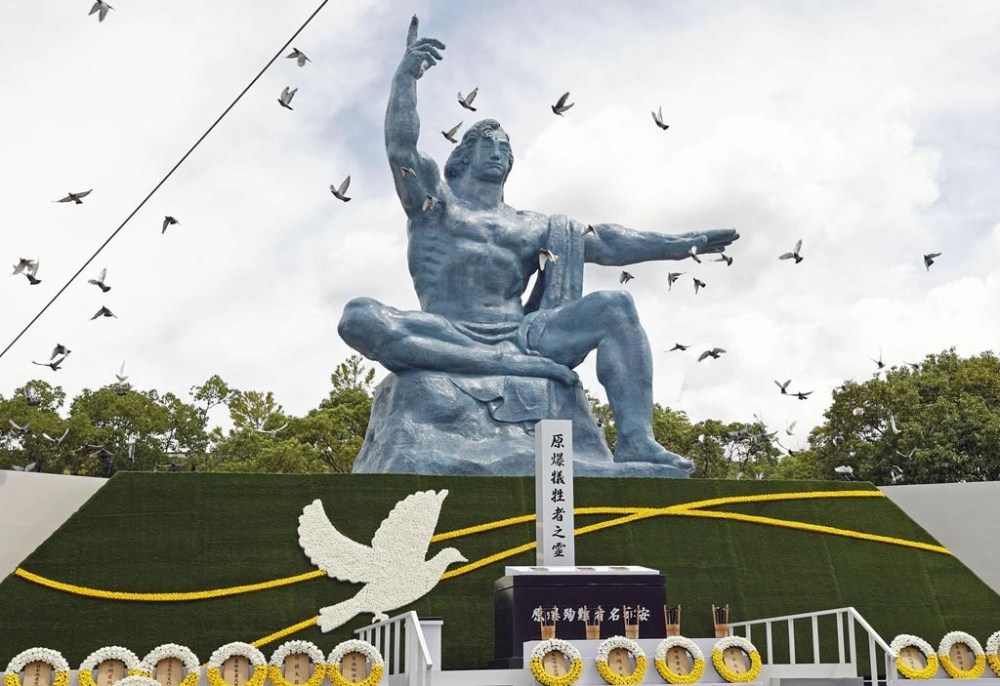 FILE - Doves fly over the Peace Statue during a ceremony to mark the 77th anniversary of the U.S. atomic bombing at the Peace Park in Nagasaki, southern Japan, on Aug. 9, 2022. (Kyodo News via AP, File)