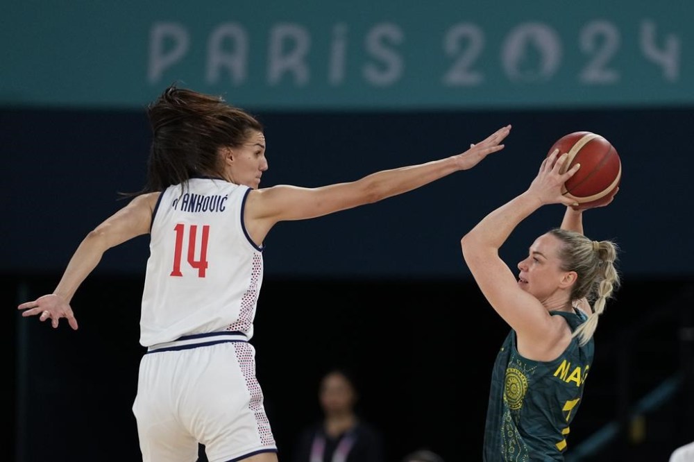 Tess Madgen (7), of Australia, shoots over Dragana Stankovic (14), of Serbia, during a women's quarterfinal game at Bercy Arena at the 2024 Summer Olympics, Wednesday, Aug. 7, 2024, in Paris, France. (AP Photo/Mark J. Terrill)
