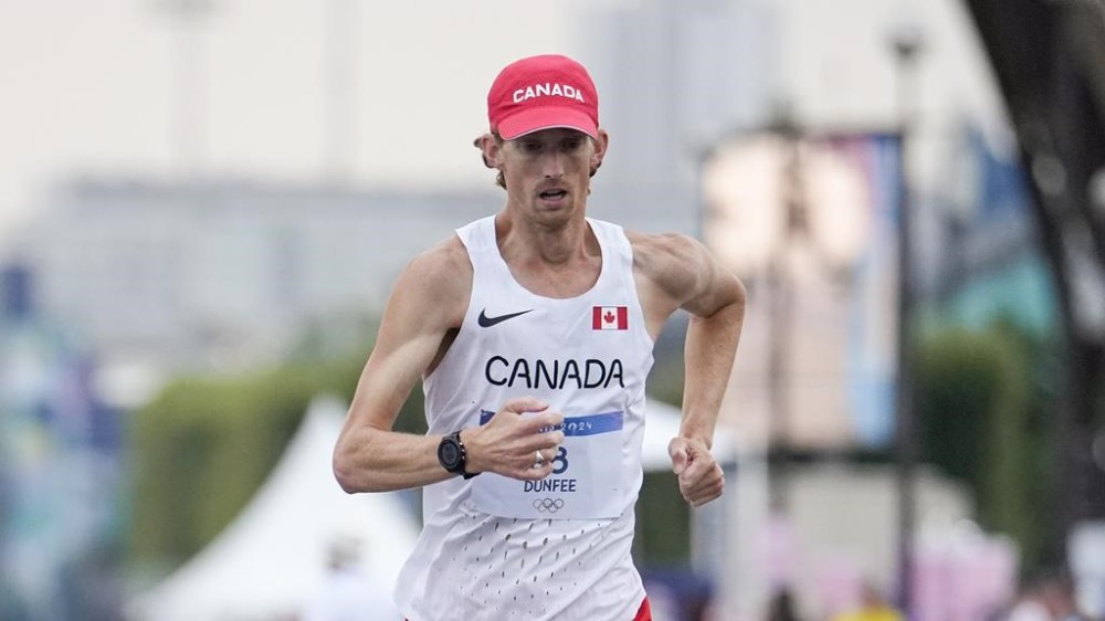 Canada's Evan Dunfee leads the pack during the marathon race walk relay mixed at the 2024 Summer Olympics, Wednesday, Aug. 7, 2024, in Paris, France. THE CANADIAN PRESS/AP/Vadim Ghirda