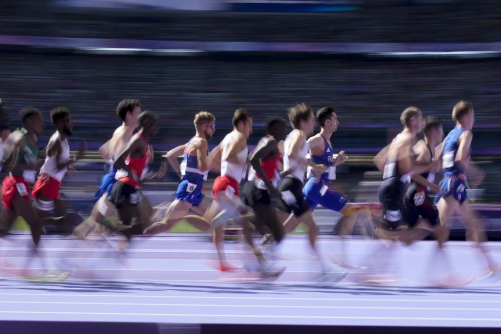 Runners compete in the men's 5000-metre heats at the 2024 Summer Olympics, Wednesday, Aug. 7, 2024, in Saint-Denis, France. THE CANADIAN PRESS/AP/Natacha Pisarenko