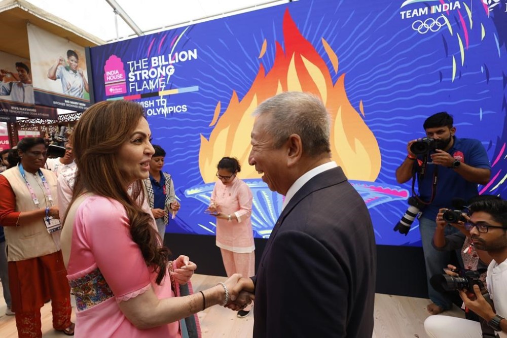 India's Nita Ambanileft, shakes hands with IOC member Ser Miang Ng, from Singapore, as she inaugurates the Indian House at the 2024 Summer Olympics, Saturday, July 27, 2024, in Paris, France. (AP Photo/Aurelien Morissard)
