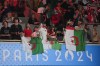 Fans of Algeria cheer ahead of Thailand's Janjaem Suwannapheng fight against Algeria's Imane Khelif in their women's 66 kg semifinal boxing match at the 2024 Summer Olympics, Tuesday, Aug. 6, 2024, in Paris, France. (AP Photo/John Locher)