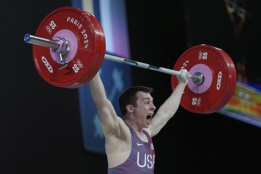 Hampton Morris of the United States competes during the men's 61kg weightlifting event at the 2024 Summer Olympics, Wednesday, Aug. 7, 2024, in Paris, France. (AP Photo/Kin Cheung)