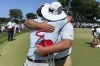 Trevor Gutschewski, left, hugs his father, PGA Tour player Scott Gutschewski, after winning the U.S. Junior Amateur Golf Championship at Oakland Hills, Saturday, July 27, 2024, in Bloomfield Township, Mich. (AP Photo/Larry Lage)