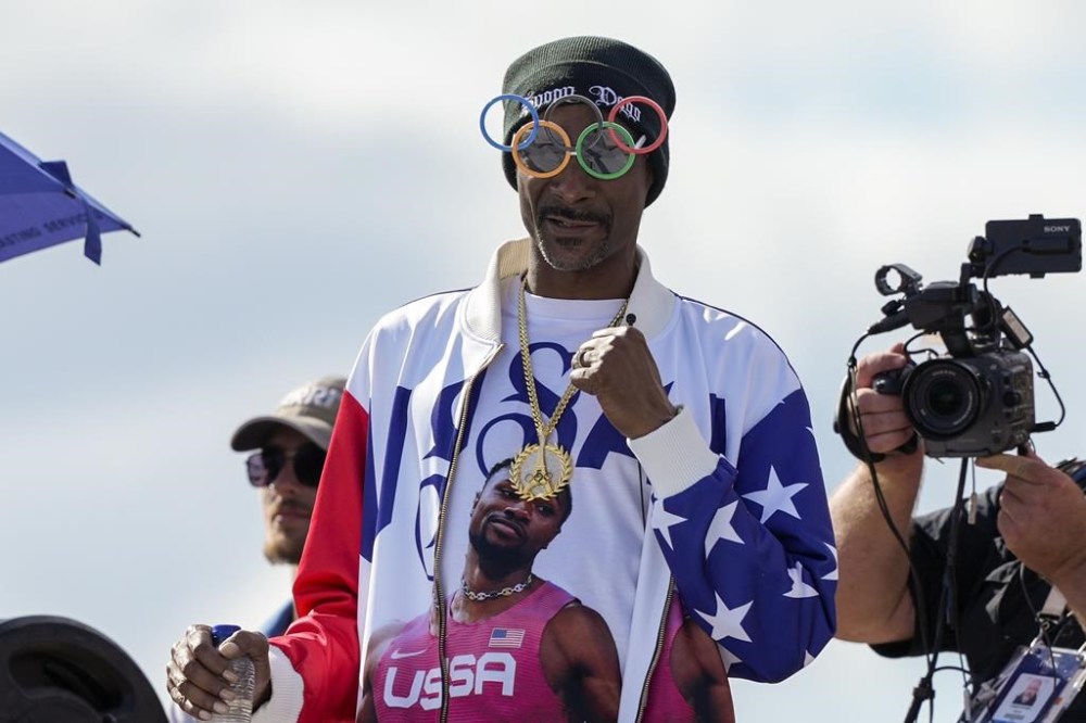 US artist Snoop Dogg gestures during the men's skateboarding park finals at the 2024 Summer Olympics, Wednesday, Aug. 7, 2024, in Paris, France. (AP Photo/Frank Franklin II)