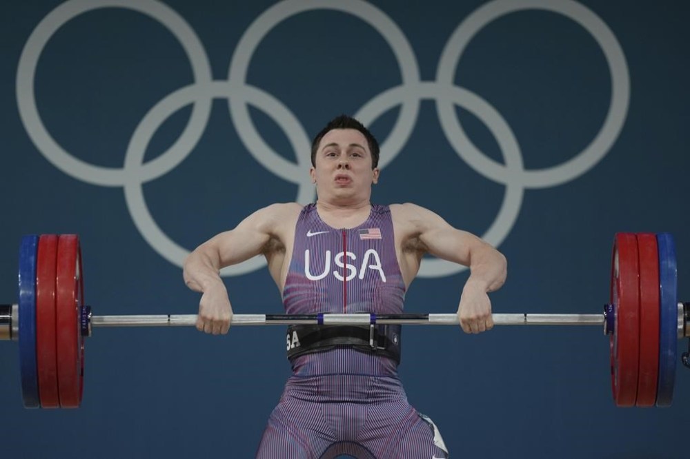 Hampton Morris of the United States competes during the men's 61kg weightlifting event at the 2024 Summer Olympics, Wednesday, Aug. 7, 2024, in Paris, France. (AP Photo/Kin Cheung)