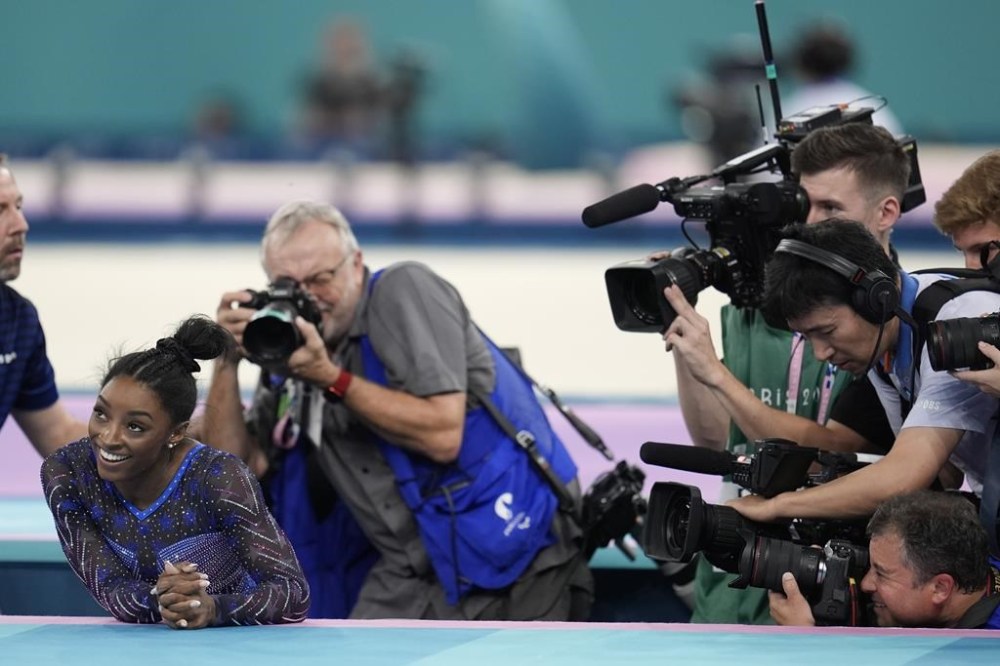 Simone Biles, of the United States, smiles after completing her floor routine during the women's artistic gymnastics all-around finals in Bercy Arena at the 2024 Summer Olympics, Thursday, Aug. 1, 2024, in Paris, France. (AP Photo/Abbie Parr)