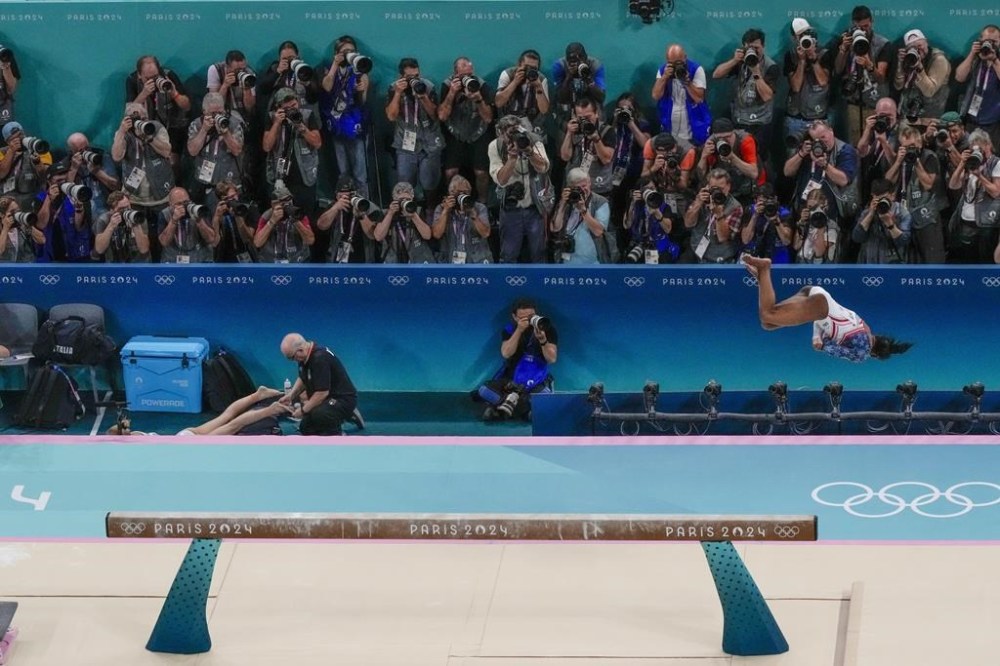 Simone Biles, of United States, performs on the beam during the women's artistic gymnastics team finals at the 2024 Summer Olympics, Tuesday, July 30, 2024, in Paris, France. (AP Photo/Morry Gash)