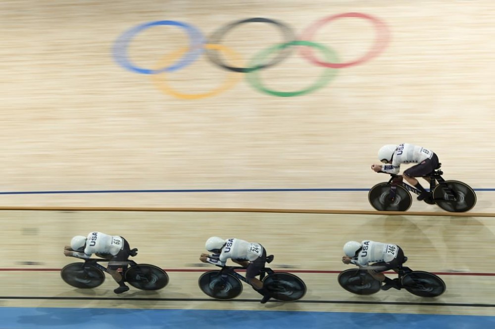 United States' Jennifer Valente, Lily Williams, Chloe Dygert and Kristen Faulkner compete on their way to clinch the gold medal in the women's team pursuit event, at the Summer Olympics, Wednesday, Aug. 7, 2024, in Paris, France. (AP Photo/Ricardo Mazalan)