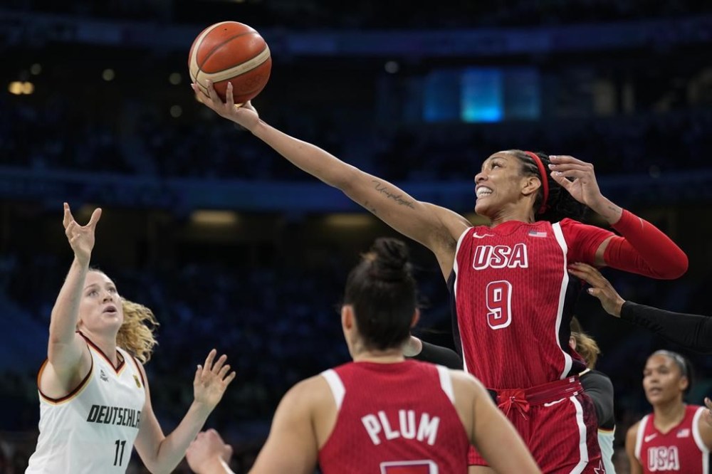 A'ja Wilson (9), of the United States, grabs a rebound over Marie Guelich (11), of Germany, in a women's basketball game at the 2024 Summer Olympics, Sunday, Aug. 4, 2024, in Villeneuve-d'Ascq, France. (AP Photo/Mark J. Terrill)