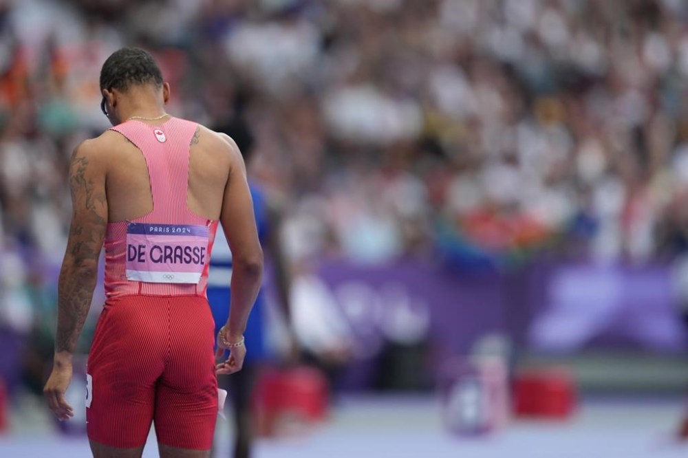 Andre De Grasse, of Canada, reacts after competing in the men’s 200-metre semifinals at the 2024 Summer Olympics, Wednesday, Aug. 7, 2024, in Saint-Denis, France. De Grasse will not be defending his Olympic title in the men's 200-metre final. The 29-year-old from Markham, Ont., finished third in his semifinal at 20.41 seconds. THE CANADIAN PRESS/Christinne Muschi