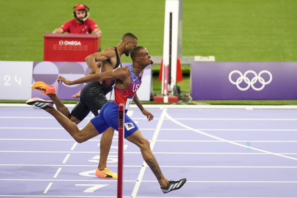 Quincy Hall, of the United States, crosses the finish line followed by Matthew Hudson-Smith, of Britain, in the men's 400-meters final at the 2024 Summer Olympics, Wednesday, Aug. 7, 2024, in Saint-Denis, France. (AP Photo/Natacha Pisarenko)