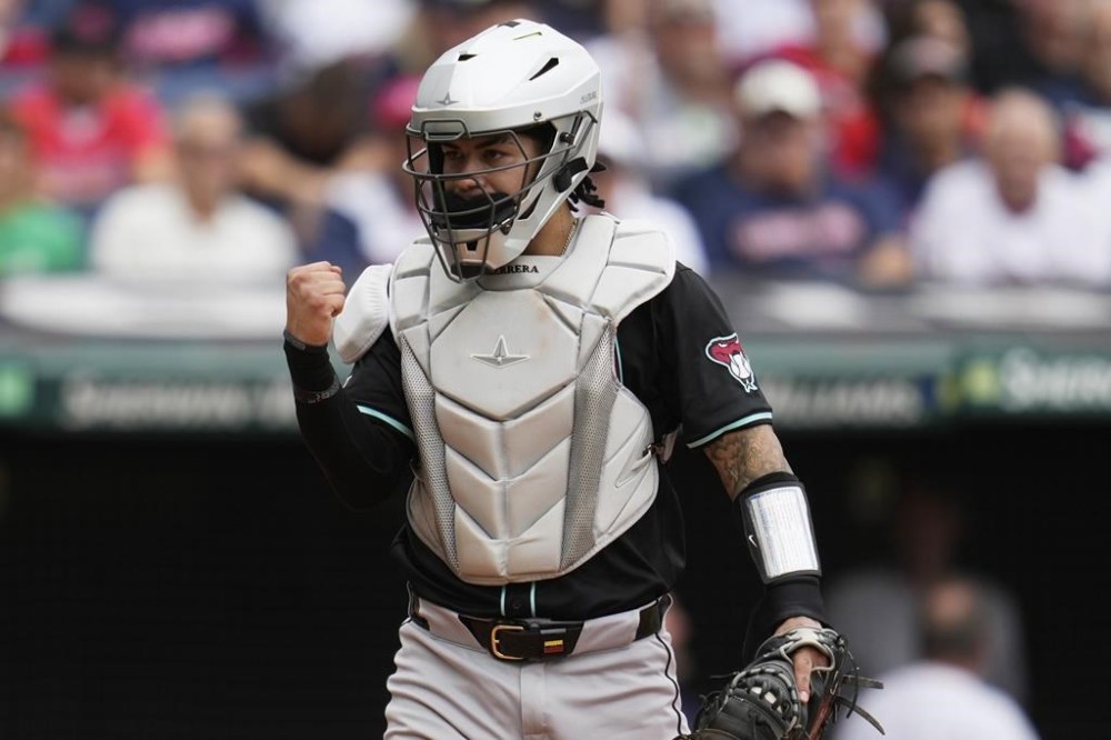 Arizona Diamondbacks catcher Jose Herrera pumps his fist after tagging out Cleveland Guardians' Daniel Schneemann at home plate in the fifth inning in the first baseball game of a doubleheader in Cleveland, Wednesday, Aug. 7, 2024. (AP Photo/Sue Ogrocki)